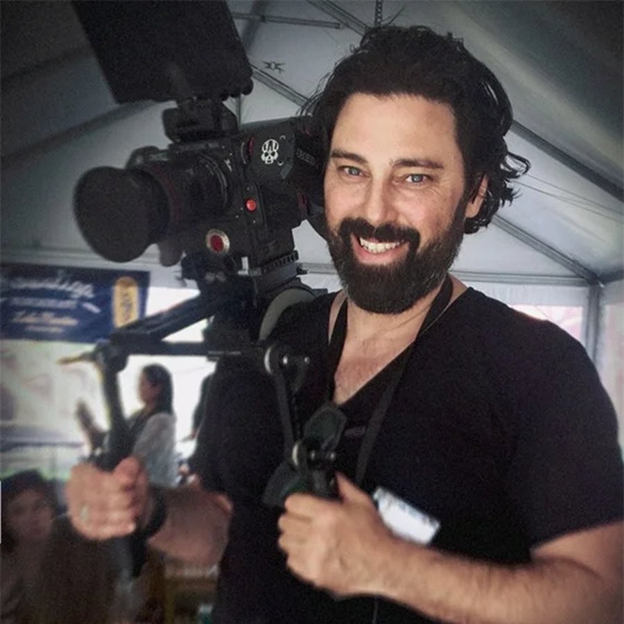 Alexander holding camera equipment
